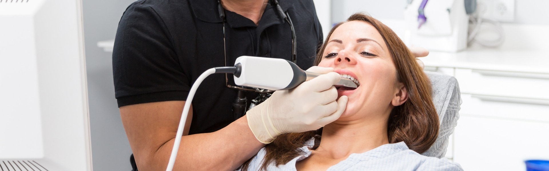 Dentist scanning patients teeth with a cerec scanner jpg