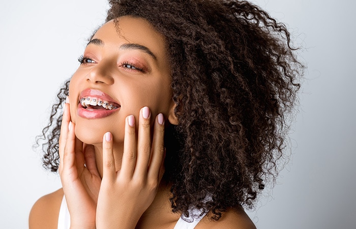 Beautiful laughing african american girl with dental braces, iso