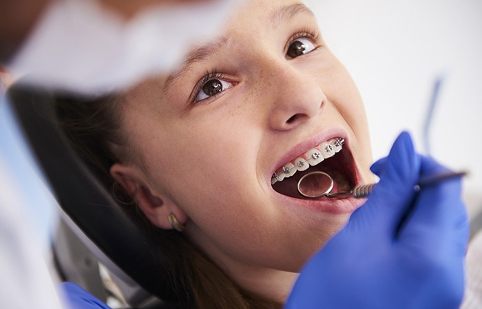 Girl with braces during a routine, dental examination