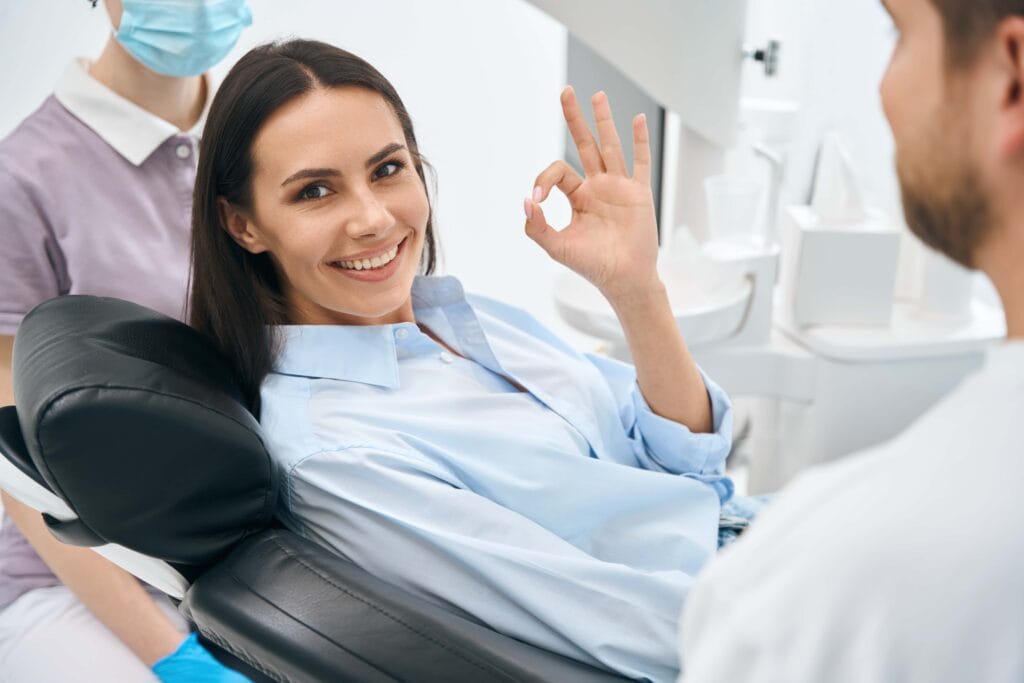 Positive woman client enjoying good service in private dental clinic, routine check up