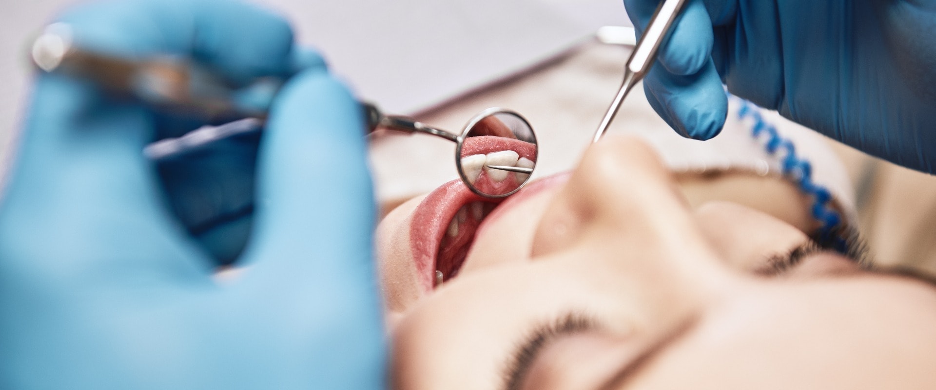 Advanced Medicine, Trusted Care. Attractive woman at the dental office. Dentist examining patient's teeth in clinic.