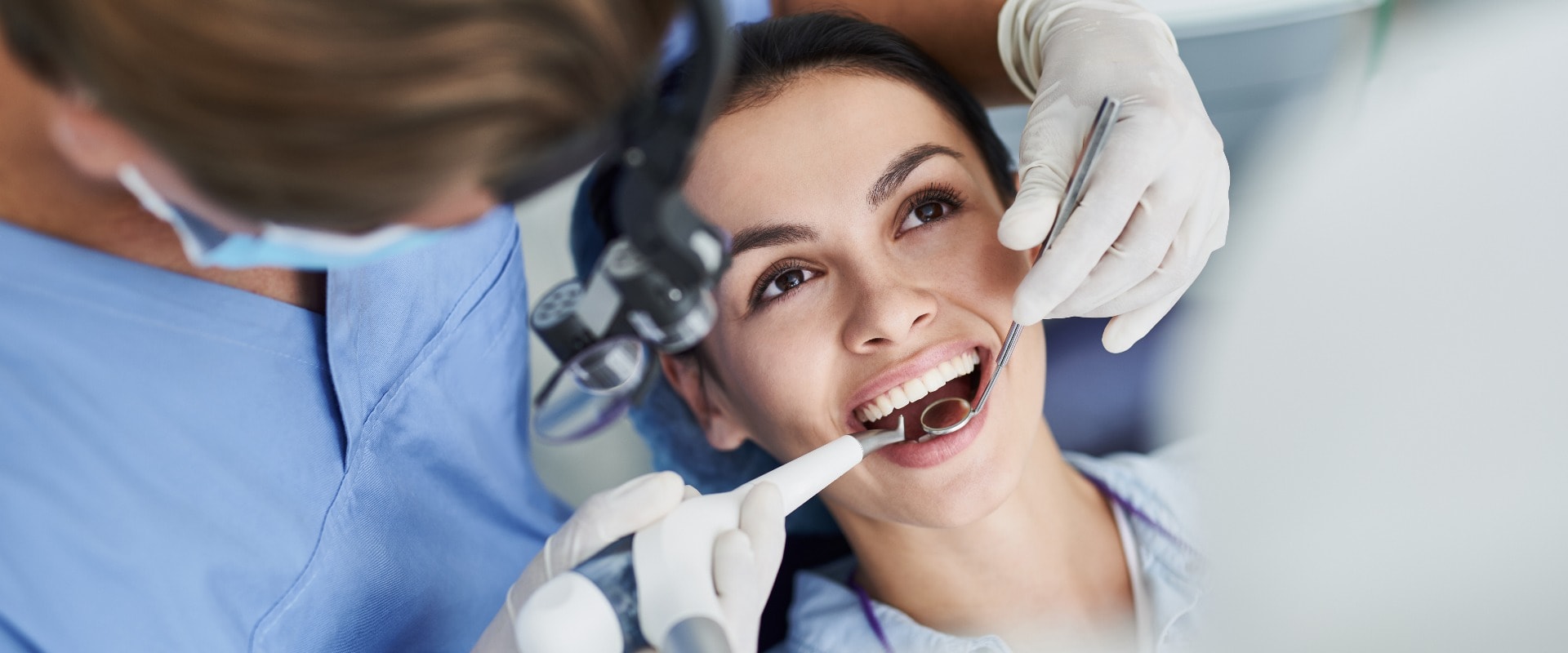 Charming young woman receiving dental treatment at clinic